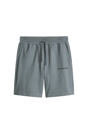 Shorts à taille élastique grise avec poches avant et cordon de serrage, ornés d'un petit texte noir "MARC O'POLO DENIM" sur la jambe droite.