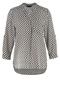 Långärmad blus i lätt tyg, med ett geometriskt mönster i svart, vitt och rost, V-ringning och rundad nederkant.