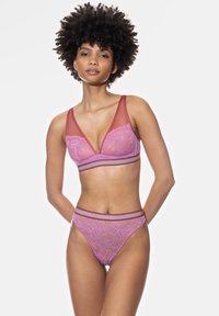 Lace bralette and matching bikini in soft pink with contrasting straps. Features floral patterns and a subtle metallic accent.