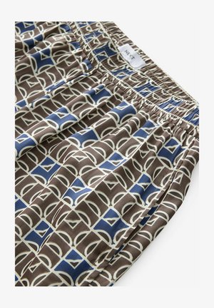 Mønstret brunt stof med hvide og blå abstrakte former. Elastisk talje øverst, glat tekstur hele vejen igennem.