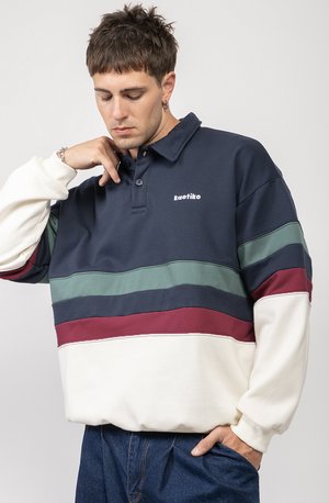 Navy blue polo sweatshirt with horizontal stripes in green, burgundy, and cream. Features a collar, embroidered logo, and relaxed fit.