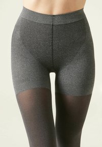 Leggings grigi ribattuti con vita alta semi-trasparente nera, caratterizzati da una consistenza morbida e una cintura elastica.