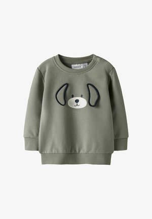 Zielona bawełniana bluza z okrągłym dekoltem, ozdobiona wzorem psa z haftowanymi uszami. Ściągacze na mankietach i u dołu dla lepszego dopasowania.