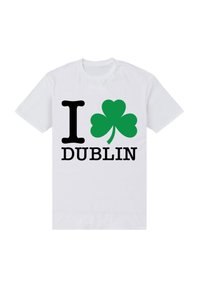 White cotton t-shirt featuring "I" in black, a green shamrock, and "DUBLIN" in black, printed centrally in bold fonts.