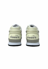 Sneaker Diadora crema e grigie con colletto alla caviglia imbottito, linguetta in rete e suola in gomma nera. Presenta il logo Diadora sul tallone.