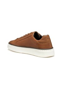 Sneaker in pelle marrone con finitura liscia, suola in gomma bianca e forma arrotondata. Caratteristiche includono chiusura con lacci e dettagli in cucitura rialzata.
