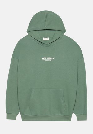 Vihreä puuvillaneule, jossa on etupuolella kengurutasku, nyörillä säädettävä huppu ja valkoiset "OFF LIMITS" -tekstit rinnassa. Pehmeä rakenne, rento istuvuus.