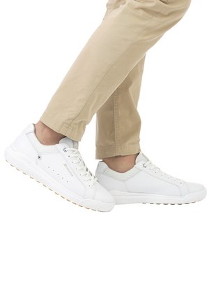 White sneakers with smooth leather and mesh panels, round toe, flat laces, and a textured rubber sole. Features subtle perforations and branding.