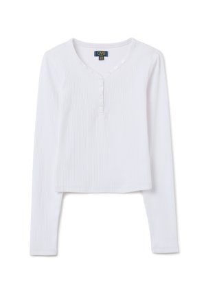 Crop top blanc à manches longues en tissu côtelé, avec un décolleté en V et cinq boutons sur le devant. Texture douce et design ajusté.