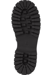 Semelle en caoutchouc noir avec des crampons profonds et des picots carrés en relief, taille 38 marquée au centre, conçue pour l'adhérence et la durabilité.