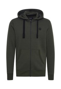 Felpa con zip verde oliva realizzata in morbido tessuto, con zip nera, cordini e due tasche frontali con polsini a coste sulle maniche.