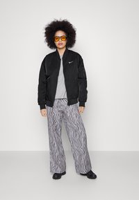 Nike Sportswear W NSW ESSNTL WVN BMR JKT IGNI - Bomber stiliaus striukė - black