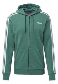 Sudadera con capucha verde de cremallera, hecha de material suave, con rayas blancas en las mangas y un logo de Adidas en el pecho. Cuenta con dos bolsillos frontales.