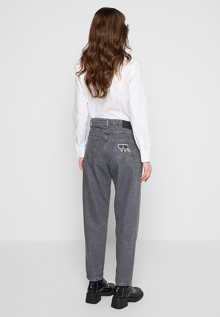 Pantaloni in denim grigio con vestibilità morbida, dotati di una cintura elastica e dettaglio di occhiali da sole ricamato sulla tasca posteriore.