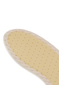 Lightweight beige insole with a textured yellow surface featuring small holes for breathability, trimmed with a soft white fabric edge.