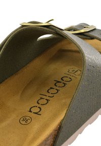 Grön sandalett med en texturerad ovandel, en guldfärgad accent och en vadderad beige fotbädd. Har en öppen tådesign och en konturerad form.