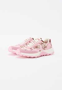 Pink sneakers with floral designs, made of textile and synthetic materials. Features white laces and chunky pink soles.