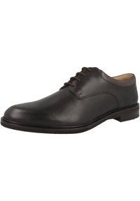 Bruin leren veterschoen met een gladde afwerking, ronde neus, lage hak en minimale stiksels. Lichtgeïnterieur met demping.