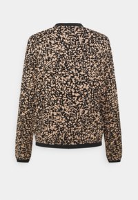 Chemise beige et noire à manches longues avec motif abstrait, poignets, col et ourlet côtelés noirs, montrée de dos sur un fond uni.