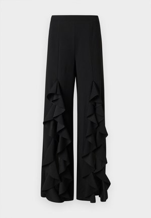 Pantalones de pierna ancha negros con acentos de volantes asimétricos a lo largo de las costuras exteriores. Fabricados con una tela suave y con una cintura ajustada.