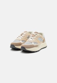 Beige- und graue Turnschuhe aus Mesh- und Wildledermaterialien, mit Schnürdesign, gepolsterter Ferse und strukturiertem Gummiaußensohle.