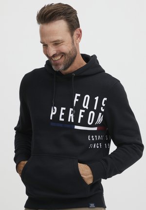 Black hooded sweatshirt with a front kangaroo pocket, featuring white and colored text graphics. Made of a soft fabric, with a relaxed fit.
