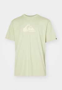 Light green cotton t-shirt featuring a large white wave logo on the chest, short sleeves, and a crew neckline. Soft, plain fabric texture.