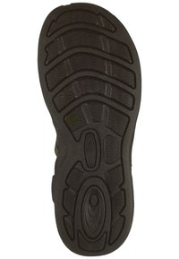 Schwarze Gummisohlen mit gewelltem Profil, erhöhten ovalen und runden Details sowie einer strukturierten Oberfläche für besseren Grip.