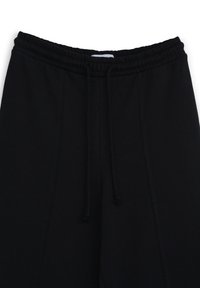 Schwarze Sweatpants mit elastischem Bund und Kordelzug. Verfügt über Seitentaschen und eine glatte, weiche Textur. Einfaches Design ohne Muster.