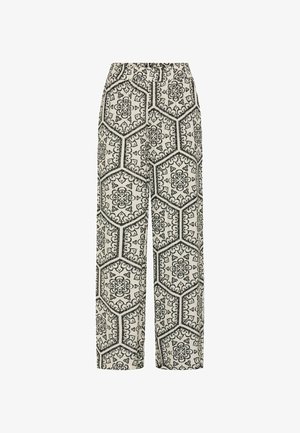 Pantalones de pierna ancha en tela crema con un patrón hexagonal geométrico y floral negro, con cintura elástica para mayor comodidad.