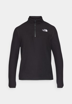 Juodas ketvirčio užtrauktuko fliso puloveris su aukšta apykakle, ilgomis rankovėmis ir baltu logotipu kairėje krūtinės pusėje. Lygus paviršius.