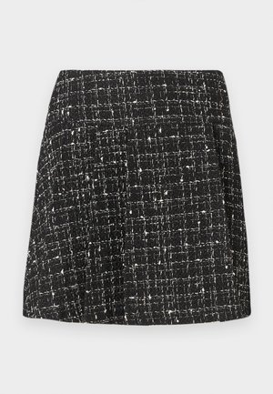 Svart-hvitt tweed skjørt med en teksturert mønstring, rett snitt og et subtilt rutemønster. Har en linning og ingen synlige festemidler.
