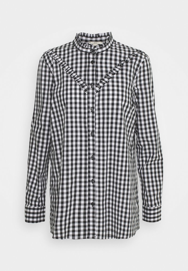 Blouse à manches longues en vichy noir et blanc avec col mandarin, boutonnée sur le devant et détails de volants en diagonale sur la poitrine.
