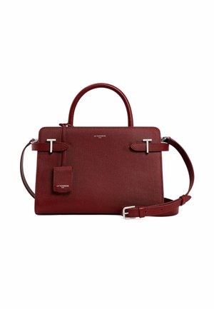 Red textured leather handbag with two handles, adjustable shoulder strap, silver hardware, and a detachable tag.