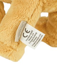 Soft yellow plush toy with a fur-like texture; features a small tag displaying care instructions and CE certification.