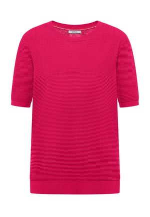 Maglione corto a manica corta di colore rosa acceso, lavorato a maglia con collo rotondo e motivo a rilievo, con etichetta "Cecil" sul colletto.