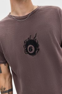 Short-sleeve, purple t-shirt made of soft fabric featuring a black graphic of a billiard ball with flames and the number 6.