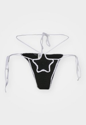 Bas de bikini au crochet noir avec une bordure blanche, en forme d'étoile au centre, doté de lanières ajustables pour un ajustement personnalisé.