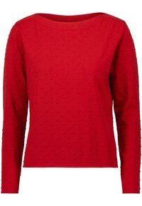 Pull rouge à manches longues en tissu tricoté texturé avec des points en relief sur toute la surface et un col rond.