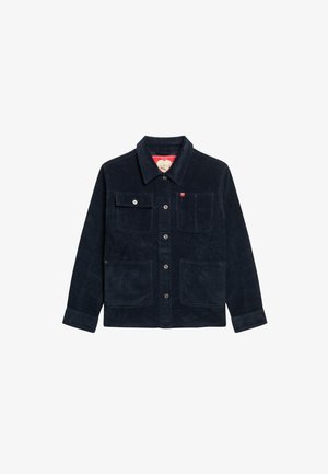 Donkerblauwe corduroyjas met een kraaghalslijn, vier voorzakken en drukknoopsluitingen. Beschikt over een contrasterende voering.