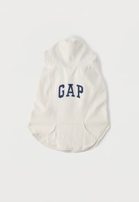 helekreemjas kapuutsiga pusa ees oleva kängurutasku, ümarate servade ja tagaküljel tumesinise "GAP" logoga. Valmistatud pehmest kangast.