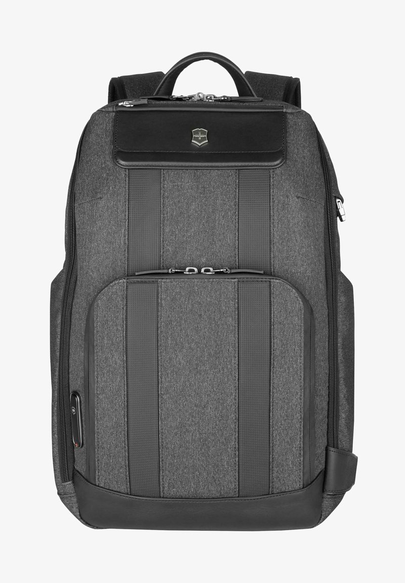 Gray fabric backpack with black leather accents, featuring vertical stripes, front zipper pocket, and padded shoulder straps.