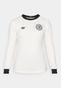White long-sleeve soccer jersey with ribbed texture, black collar and cuffs, featuring a black logo with text and an adidas emblem on the chest.