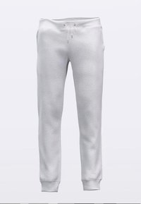 Valged fliisist dressipüksid nööriga vöökohas, kitsenevate säärte ja soonikuga lõppudega. Pehme tekstuur ja peened õmblused.