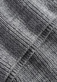 Close-up of folded gray knitted fabric with ribbed texture showing intertwined stitches and soft wool fibers.