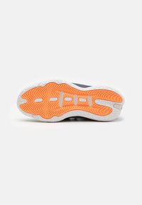 Athletic shoe outsole with a white base, featuring an orange textured grip pattern and grooves for flexibility. Rubber material used.