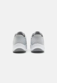 Gray athletic shoes with textured mesh upper, white midsole, and rubber outsole. Features a padded collar and minimal branding on the heel.