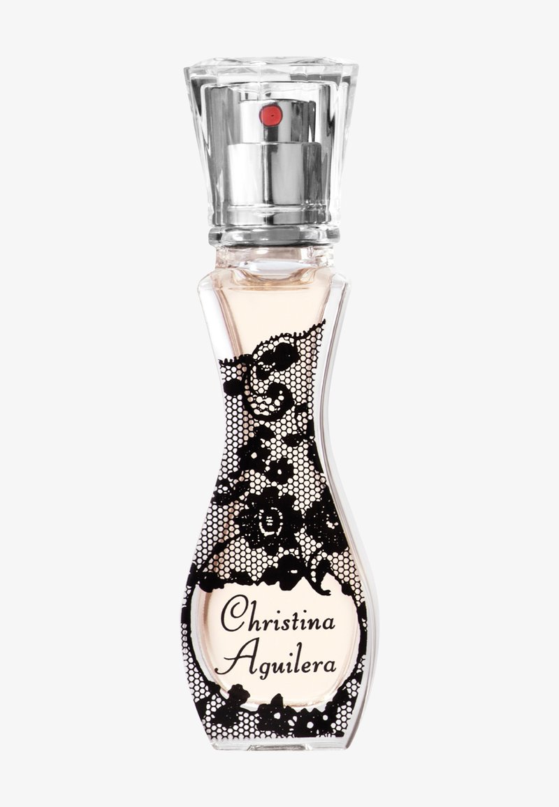 Flacon de parfum en verre courbé avec motif dentelle noire, vaporisateur argenté et "Christina Aguilera" écrit en lettres noires calligraphiées sur le devant.