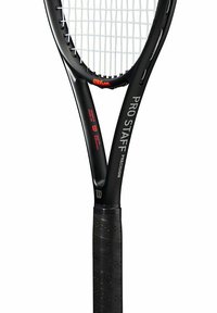 Black tennis racquet featuring a textured grip, elongated head, and string pattern, with "PRO STAFF" and "PRECISION" printed on the frame.