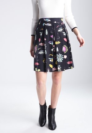 Black pleated skirt featuring a colorful pattern of eyes, lips, and flowers. Made of smooth fabric with a fitted waistband and side zipper.